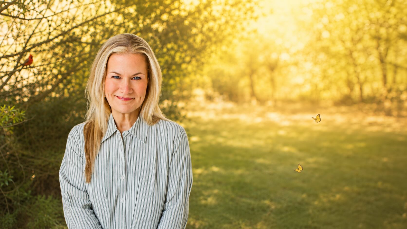 Marian Kalvert standing in soft natural light among trees